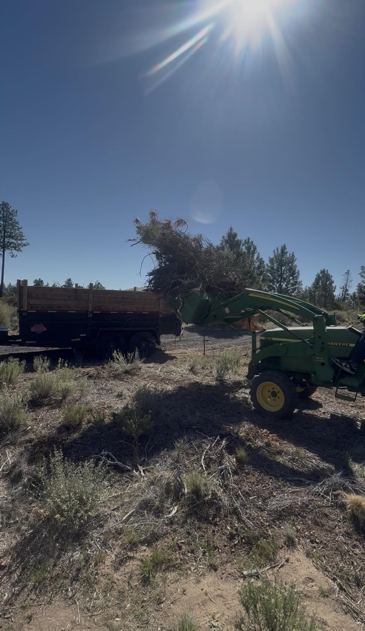 Brush hauling and acreage cleanup using tractor equipment in Central Oregon